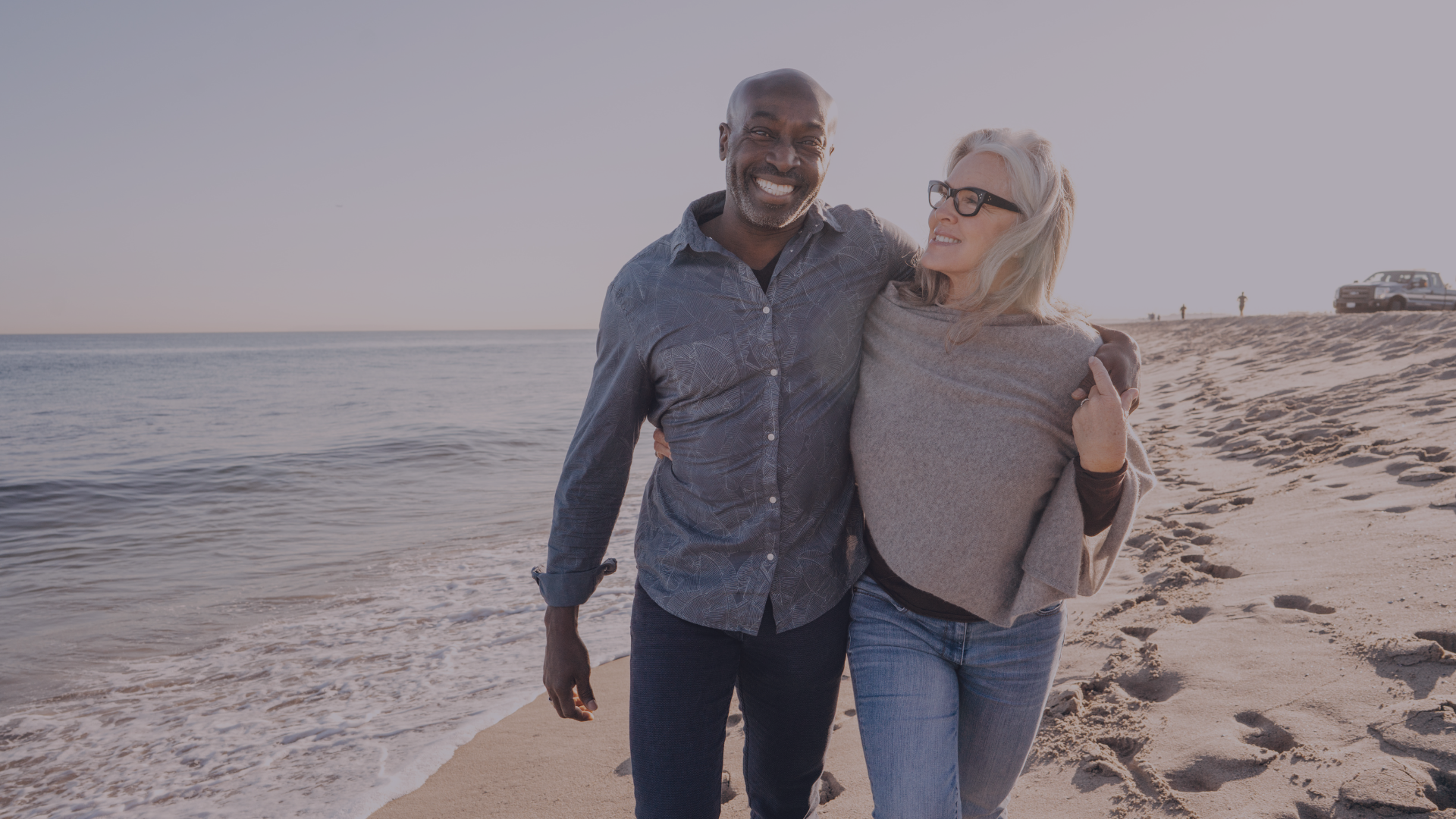 Mature couple walking along beach